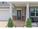 Inviting front entry with decorative door, stone accents, and manicured shrubbery at 3008 Dundee Ln, Fort Mill, SC 29707