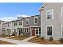 Three modern townhomes with stone accents, modern windows, and beautiful landscaped yards at 4109 Walking Ridge Rd # 57, Charlotte, NC 28208