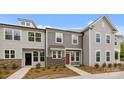 Three modern townhomes with stone accents, modern windows, and beautiful landscaped yards at 4109 Walking Ridge Rd # 57, Charlotte, NC 28208
