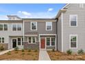 Charming gray townhome with stone accents, modern windows and pathway to the front door at 4109 Walking Ridge Rd # 57, Charlotte, NC 28208