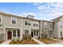 Attractive townhome featuring a mix of stone and neutral siding at 4113 Walking Ridge Rd # 56, Charlotte, NC 28208