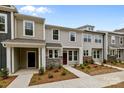 Charming townhome boasts gray siding, stone accents, and a welcoming front entrance at 4117 Walking Ridge Rd # 55, Charlotte, NC 28208
