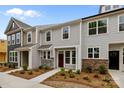 Charming townhome boasts gray siding, stone accents, and a welcoming front entrance at 4117 Walking Ridge Rd # 55, Charlotte, NC 28208