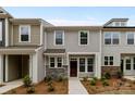 Inviting townhouse showcasing stone accents, gray siding and a well manicured landscape at 4117 Walking Ridge Rd # 55, Charlotte, NC 28208