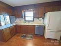 Galley kitchen featuring wood cabinets, laminate counters, and stainless steel appliances at 4866 E Nc Hwy 150 Hwy, Lincolnton, NC 28092