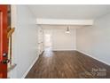 Bright living room showcasing hardwood floors, fresh paint, and staircase access at 6322 Old Pineville Rd # E, Charlotte, NC 28217
