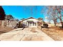 Cozy white cottage with brick accents, a covered entrance, and a cracked driveway at 742 Aquadale Rd, Albemarle, NC 28001