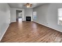 Spacious open-concept living room featuring a fireplace and wood-look flooring at 8353 Ainsworth St, Charlotte, NC 28216