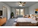 Cozy bedroom with a ceiling fan, natural light, and neutral decor at 8353 Ainsworth St, Charlotte, NC 28216