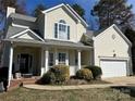 Charming two-story traditional home with a welcoming front porch and well-maintained landscaping at 10550 Worsley Ln, Charlotte, NC 28269