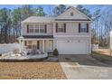 Daytime shot of a charming two-story home featuring manicured landscaping and a two-car garage at 10816 Pointer Ridge Dr, Charlotte, NC 28214
