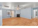 Bright living room features a fireplace, hardwood floors and a ceiling fan at 10816 Pointer Ridge Dr, Charlotte, NC 28214
