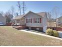 Side view of a single-story house with a driveway and a well-manicured lawn at 115 Scotch Irish Ln, Troutman, NC 28166