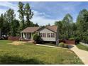 Inviting single-story home with a manicured lawn, landscaped garden, and a cozy front porch at 115 Scotch Irish Ln, Troutman, NC 28166