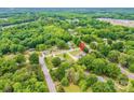 An aerial view of the property nestled within a lush, green, tree-filled neighborhood at 119 Era St, Troutman, NC 28166
