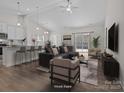 Bright, open-concept living room boasts modern furnishings and a seamless flow to the outdoor patio at 127 Tradesmen Trl, Troutman, NC 28166