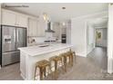 Bright kitchen featuring white cabinets, stainless steel appliances and an island with barstool seating at 1614 Shoals Ave # 151, Belmont, NC 28012