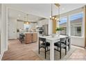 Open-concept dining area with modern lighting, and easy access to a chef-inspired kitchen at 1615 Shoals Ave # 158, Belmont, NC 28012