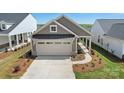 Beautiful gray home with a two-car garage, walkway, and inviting curb appeal at 1615 Shoals Ave # 158, Belmont, NC 28012