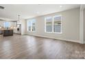 Spacious living room featuring hardwood floors, white walls, and lots of light at 1615 Shoals Ave # 158, Belmont, NC 28012