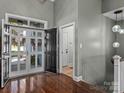 Bright foyer with hardwood floors, grand front door, and a view into the home's open layout at 1742 Verdict Ridge Dr, Denver, NC 28037