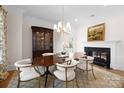 Charming dining room featuring a fireplace, elegant chandelier, and stylish decor at 1754 Sterling Rd, Charlotte, NC 28209