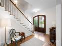 Elegant foyer with hardwood floors, staircase, and grand wooden door at 1754 Sterling Rd, Charlotte, NC 28209