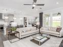 Open-concept living room boasts comfortable seating, natural light, and seamless access to the kitchen at 1914 Sparkling Stream Dr # 057, Belmont, NC 28012