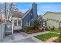 Charming blue brick home with landscaped yard and quaint architectural details at 204 Sylvania Ave, Charlotte, NC 28206