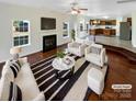 Bright living room with a fireplace, seamlessly connecting to the kitchen through an open-concept design at 215 Madelia Pl, Mooresville, NC 28115