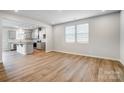 Bright living room with hardwood floors, recessed lighting, and an open layout leading to the kitchen at 2300 Hedgecliff Rd # 160, Kannapolis, NC 28025