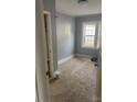 Cozy bedroom with carpet, light blue walls, natural light, and closet perfect for comfortable living at 2404 Booker Ave, Charlotte, NC 28216