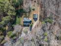 A birds-eye view of the property, featuring a home with a detached garage and surrounded by trees at 246 Jerry Crump Rd, Lincolnton, NC 28092