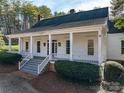 Inviting white home with a spacious front porch, complete with elegant columns and landscaped bushes at 246 Jerry Crump Rd, Lincolnton, NC 28092