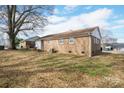 The back of a brick home with a big yard on a sunny day at 2832 Gail Ave, Gastonia, NC 25052