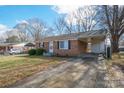 A brick home with a covered carport extending from the side of the house at 2832 Gail Ave, Gastonia, NC 25052