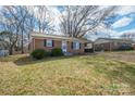 Well-kept brick home with a covered driveway and a neatly manicured front lawn at 2832 Gail Ave, Gastonia, NC 25052