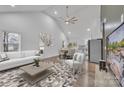 Bright living room featuring vaulted ceilings, modern decor, and an open layout to dining and kitchen spaces at 2853 W Zion Church Rd, Shelby, NC 28150