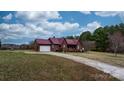 Exterior home view featuring a red metal roof, long driveway and an attached two-car garage at 3427 Joe Johnson Rd, Catawba, NC 28609