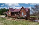 Charming exterior home view with a covered porch, wood siding, and manicured landscaping at 3427 Joe Johnson Rd, Catawba, NC 28609