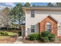 Close-up of a townhome featuring a brick facade and well-maintained landscaping at 3610 Melrose Cottage Dr, Matthews, NC 28105