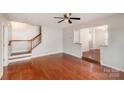 Bright living room with hardwood floors and staircase leading to the upper level at 3610 Melrose Cottage Dr, Matthews, NC 28105