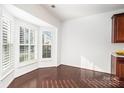 Bright breakfast nook with wood floors and white plantation shutters at 3822 Carl Parmer Dr, Harrisburg, NC 28075