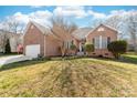 Charming brick home featuring a two-car garage and well-manicured lawn at 3851 Yellow Jasmine Dr, Gastonia, NC 28056