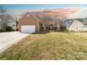 Charming brick home featuring a two-car garage and well-manicured lawn at 3851 Yellow Jasmine Dr, Gastonia, NC 28056