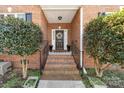 Charming brick home featuring a welcoming front porch with well-manicured shrubs at 3851 Yellow Jasmine Dr, Gastonia, NC 28056