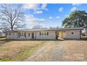 A one-story home showcasing a driveway and an open carport at 41 Fleetwood Sw Dr # 44, Concord, NC 28027