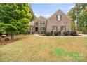 Beautiful brick home with mature landscaping and manicured lawn, creating an inviting curb appeal at 472 Barber Loop, Mooresville, NC 28117