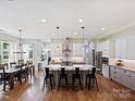 Spacious eat-in kitchen featuring an expansive island with seating, stainless steel appliances and hardwood flooring at 5941 Legacy Ln, Kannapolis, NC 28081