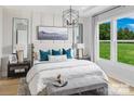 Stylishly decorated main bedroom featuring a large window, wood floors and neutral decor at 6005 Valehaven Pl # 0049, Charlotte, NC 28269